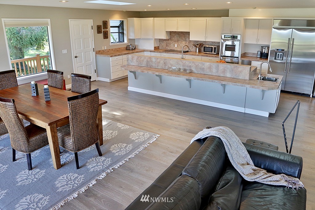 1835 Lancaster Road Freeland, WA 98249 - Photo 10 of 25 a living room with granite countertop furniture a sink a dining table and chairs
