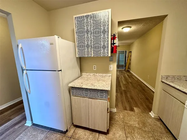 a kitchen with a refrigerator and a stove