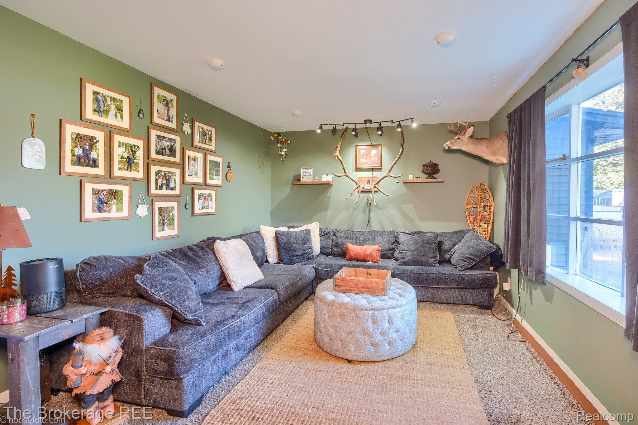 6288 Porter Road Grand Blanc, MI 48439 - Photo 9 of 39 Living room featuring baseboards and track lighting