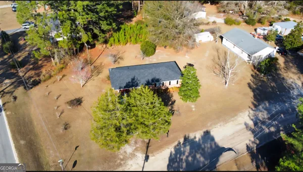 an aerial view of a house with a yard