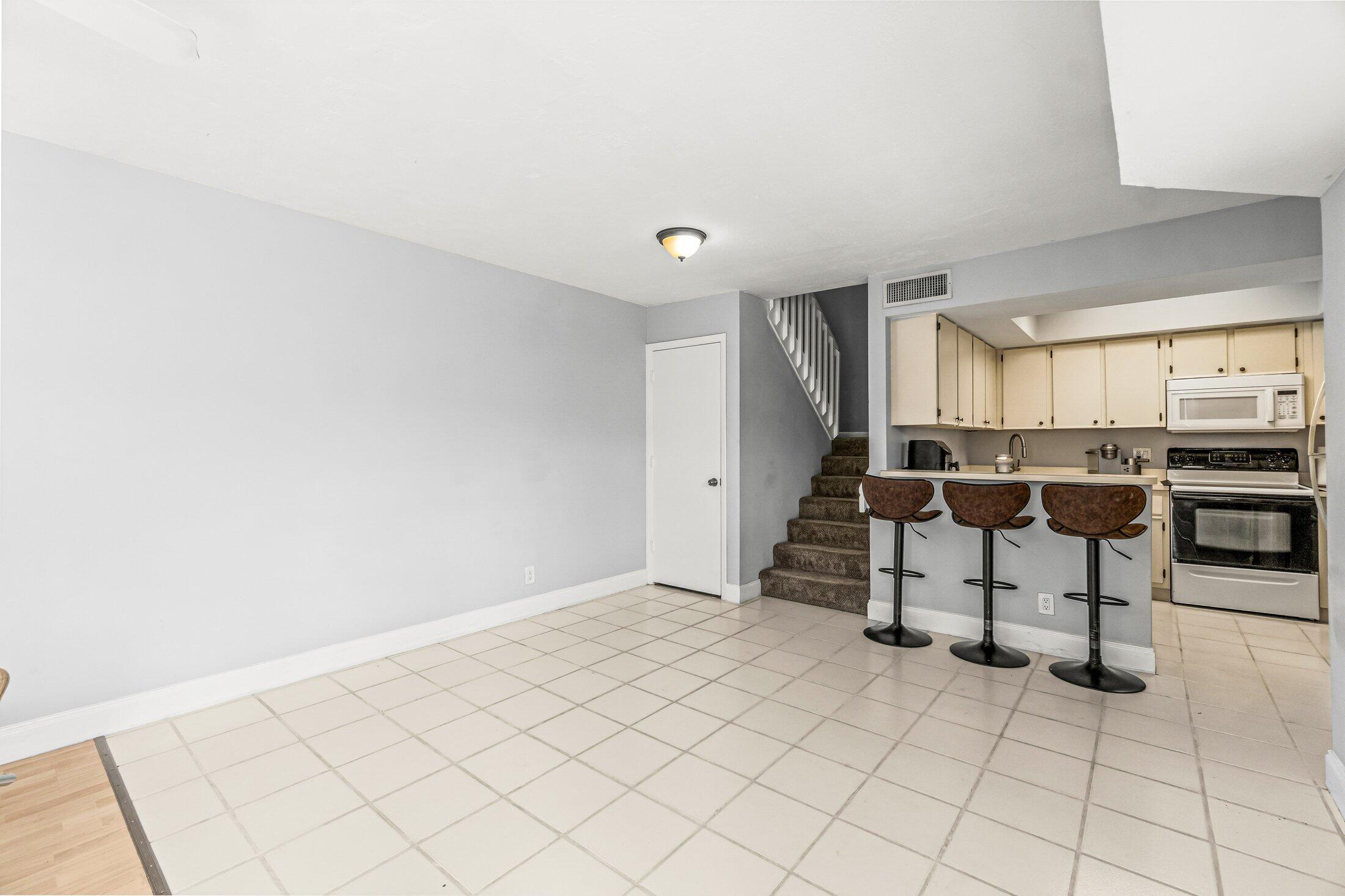 3900 Village Drive, Unit D Delray Beach, FL 33445 - Photo 14 of 43 Dining area facing stairs