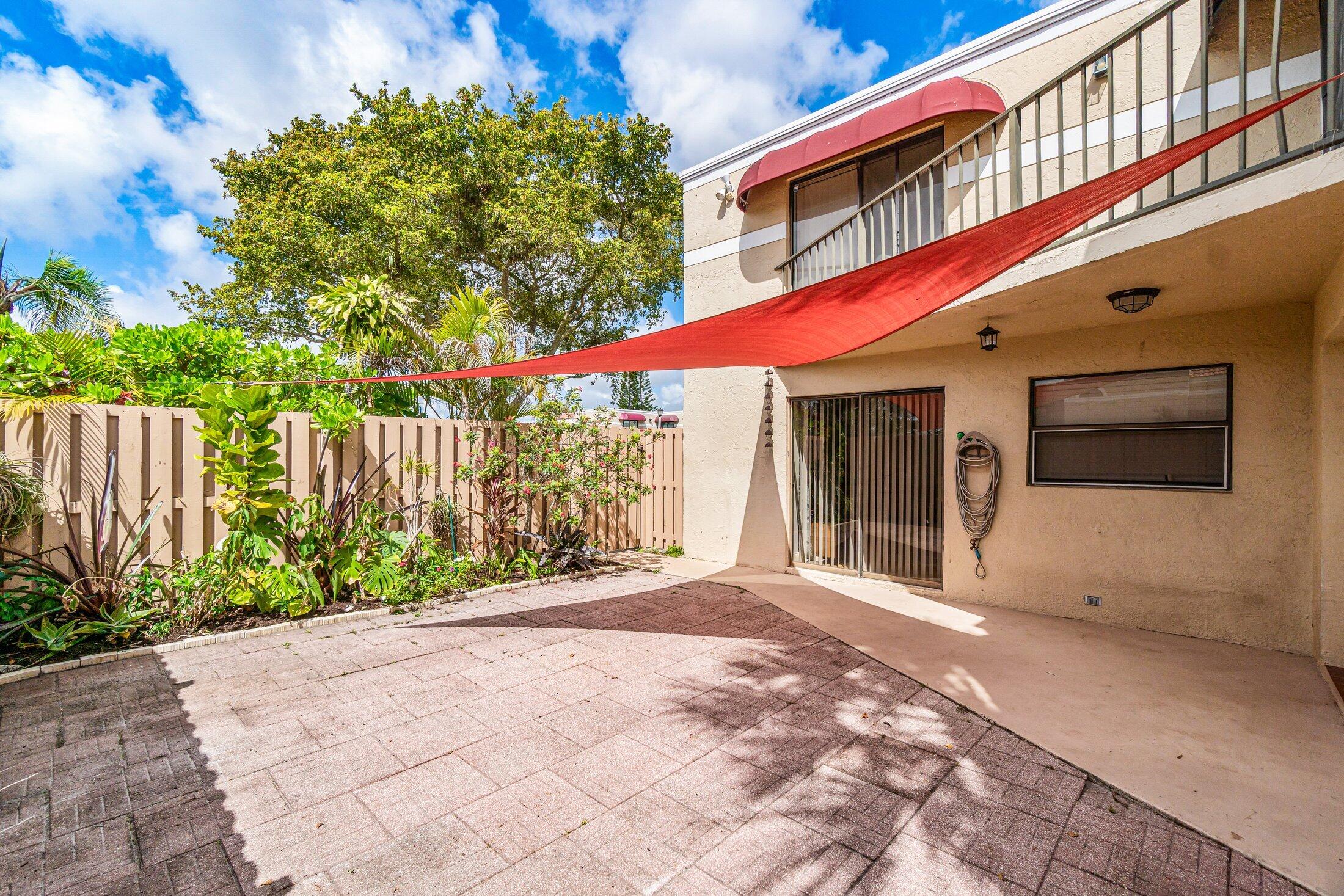 3900 Village Drive, Unit D Delray Beach, FL 33445 - Photo 6 of 43 Courtyard facing entry gate.