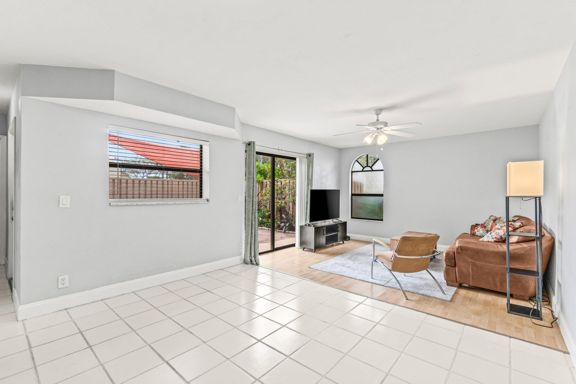 3900 Village Drive, Unit D Delray Beach, FL 33445 - Photo 10 of 43 Living dining with sliders to courtyard