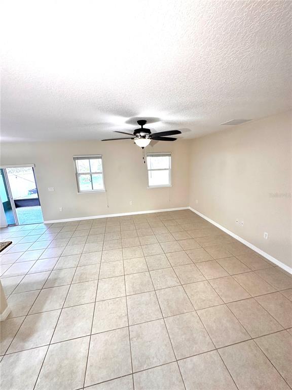 447 Pinecrest Loop Davenport, FL 33837 - Photo 16 of 23 a view of an empty room and window