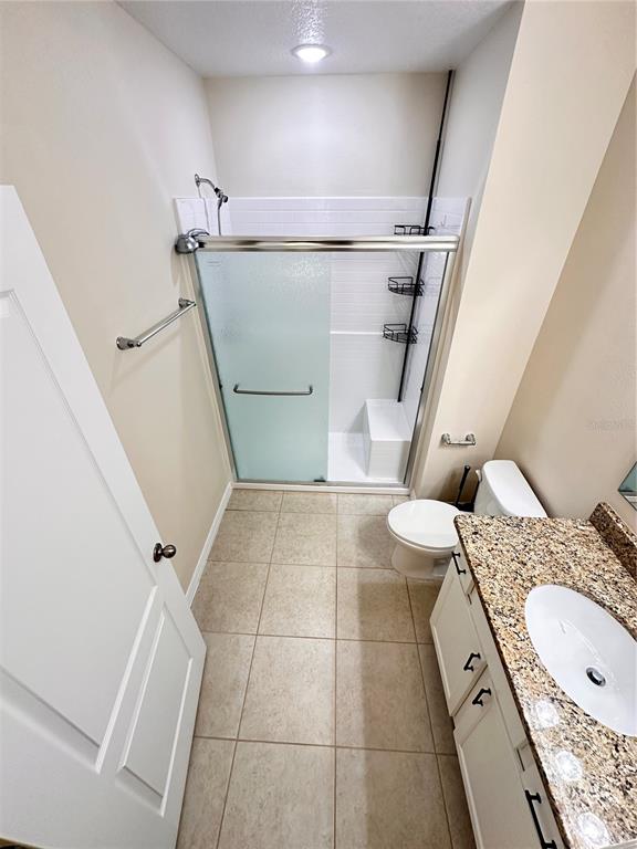 447 Pinecrest Loop Davenport, FL 33837 - Photo 21 of 23 a bathroom with a sink a toilet and shower