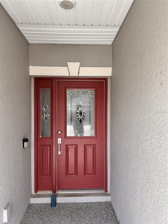 447 Pinecrest Loop Davenport, FL 33837 - Photo 3 of 23 a view of front door with red door