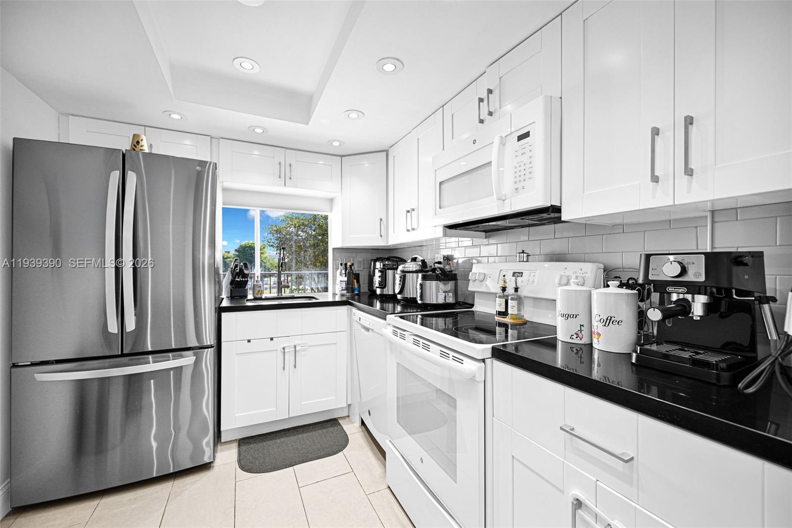 9441 Southwest 4th Street, Unit 309 Miami, FL 33174 - Photo 13 of 44 a kitchen with cabinets and stainless steel appliances
