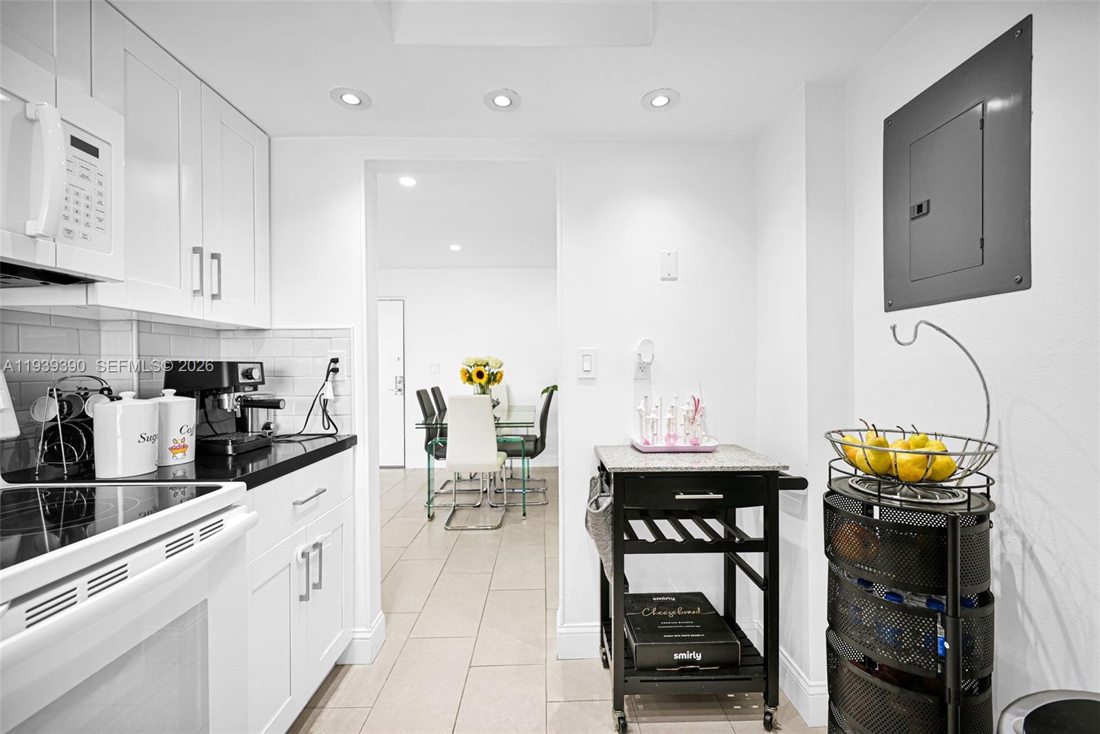 9441 Southwest 4th Street, Unit 309 Miami, FL 33174 - Photo 16 of 44 a kitchen with stainless steel appliances kitchen island granite countertop a sink and cabinets