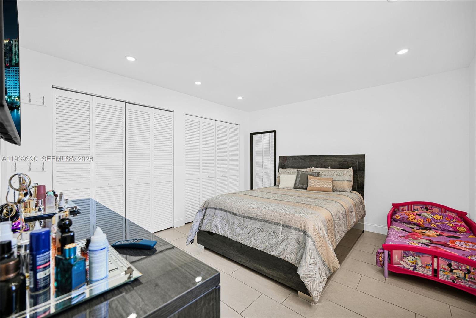 9441 Southwest 4th Street, Unit 309 Miami, FL 33174 - Photo 17 of 44 a bedroom with a bed and dresser