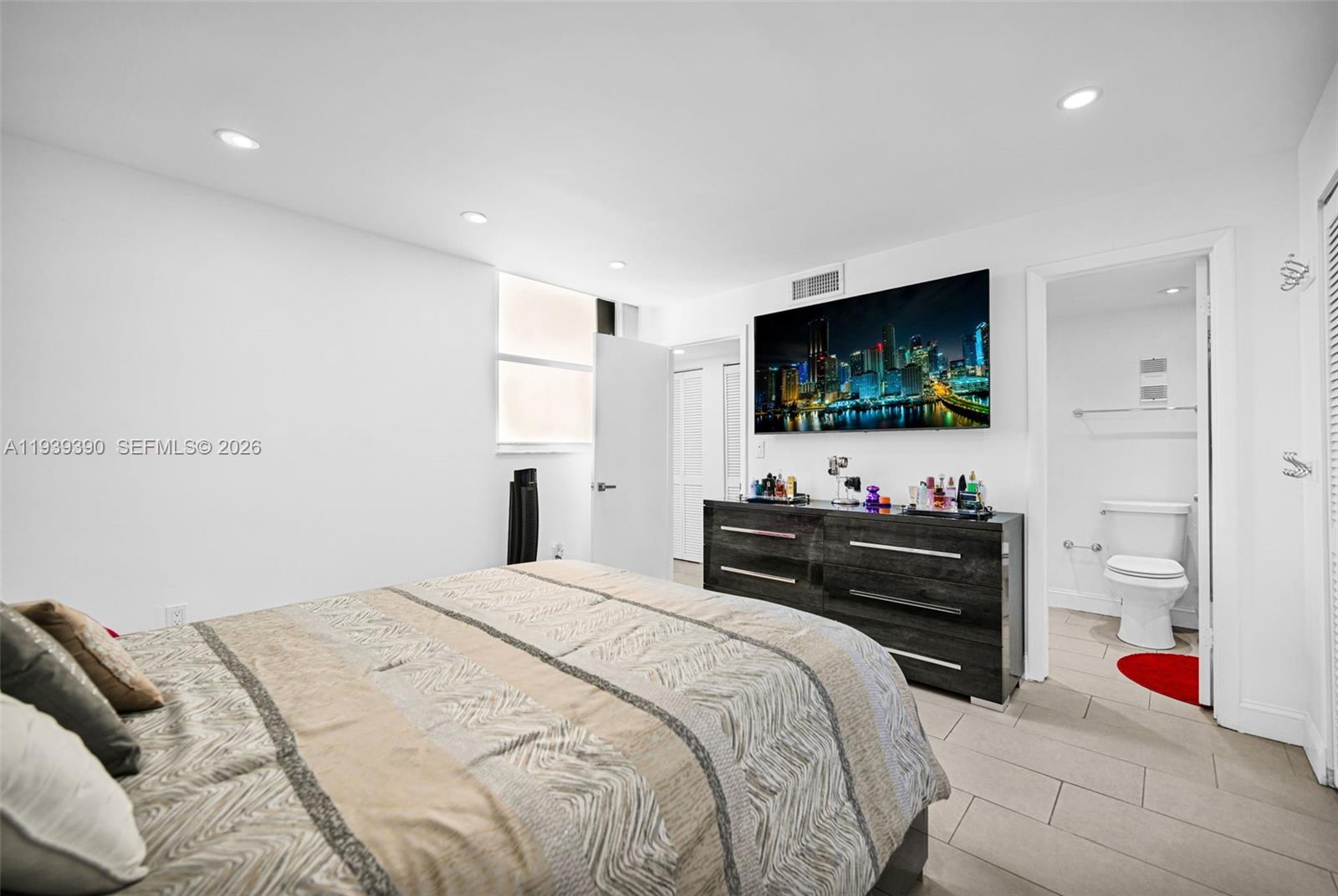 9441 Southwest 4th Street, Unit 309 Miami, FL 33174 - Photo 19 of 44 a bedroom with a bed and a flat screen tv