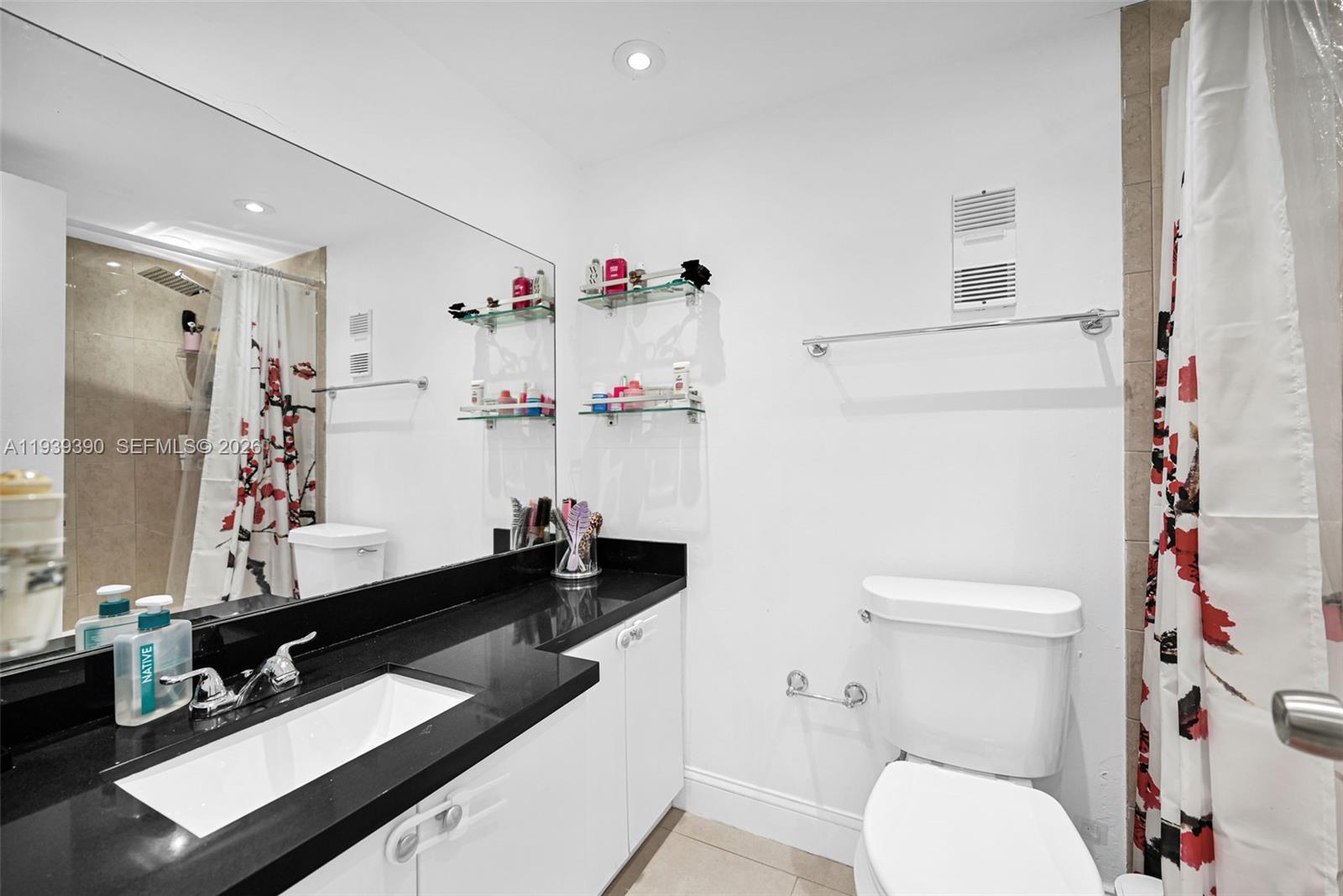 9441 Southwest 4th Street, Unit 309 Miami, FL 33174 - Photo 20 of 44 a bathroom with a sink vanity mirror and toilet
