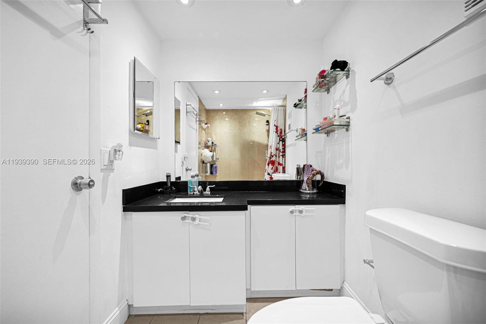 9441 Southwest 4th Street, Unit 309 Miami, FL 33174 - Photo 21 of 44 a bathroom with a sink a toilet and a mirror