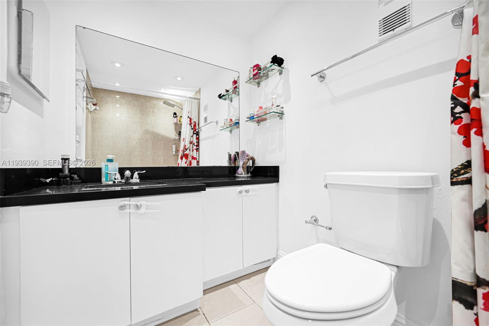 9441 Southwest 4th Street, Unit 309 Miami, FL 33174 - Photo 22 of 44 a bathroom with a sink a toilet and a mirror