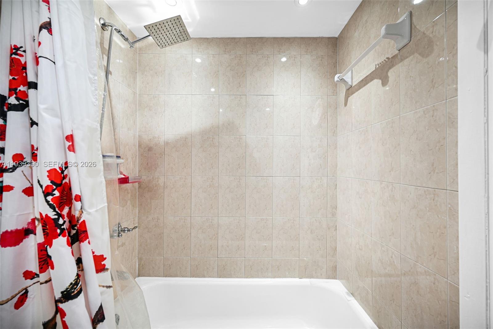 9441 Southwest 4th Street, Unit 309 Miami, FL 33174 - Photo 23 of 44 a bathroom with a bathtub and shower curtain