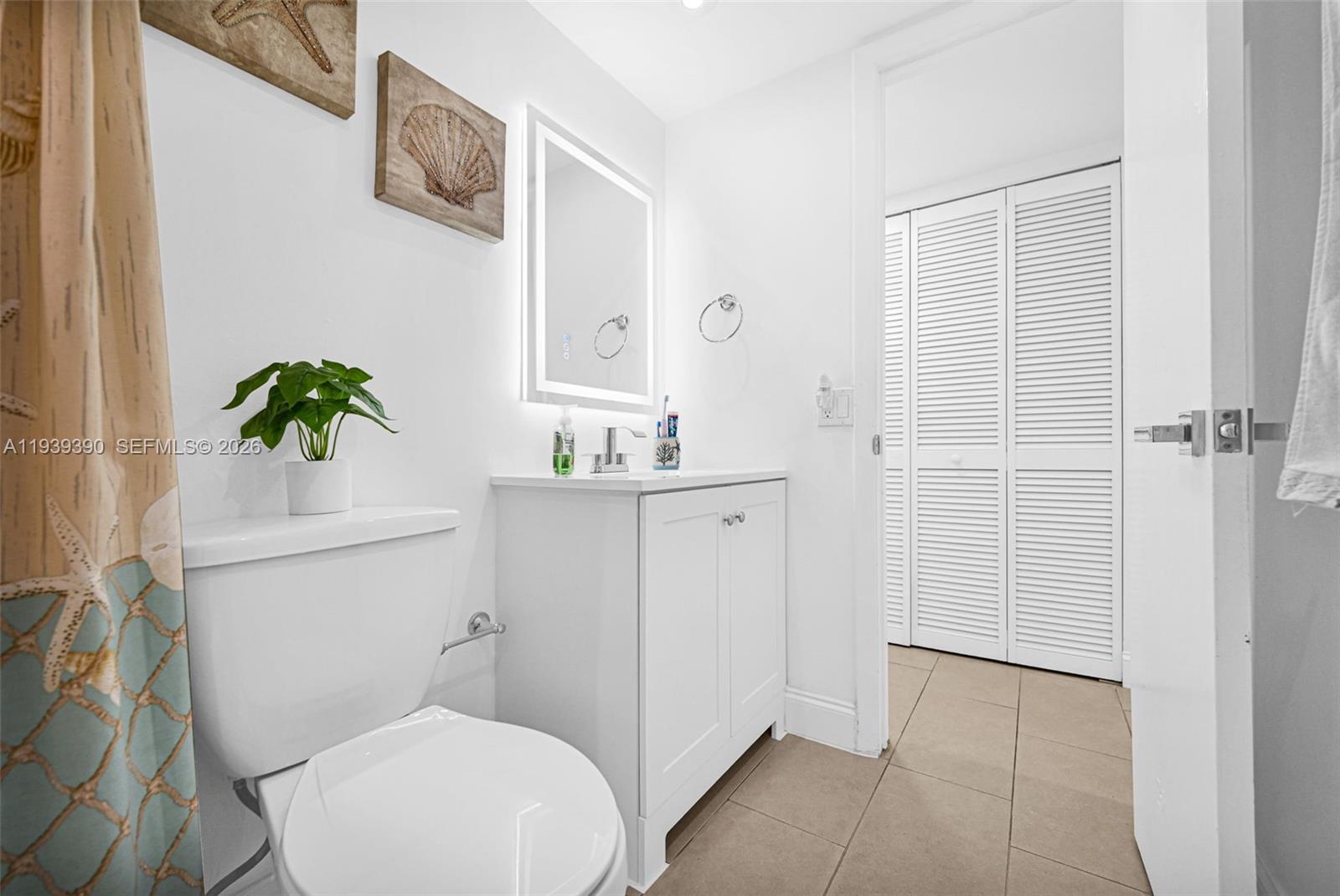 9441 Southwest 4th Street, Unit 309 Miami, FL 33174 - Photo 28 of 44 a bathroom with a sink a toilet and shower