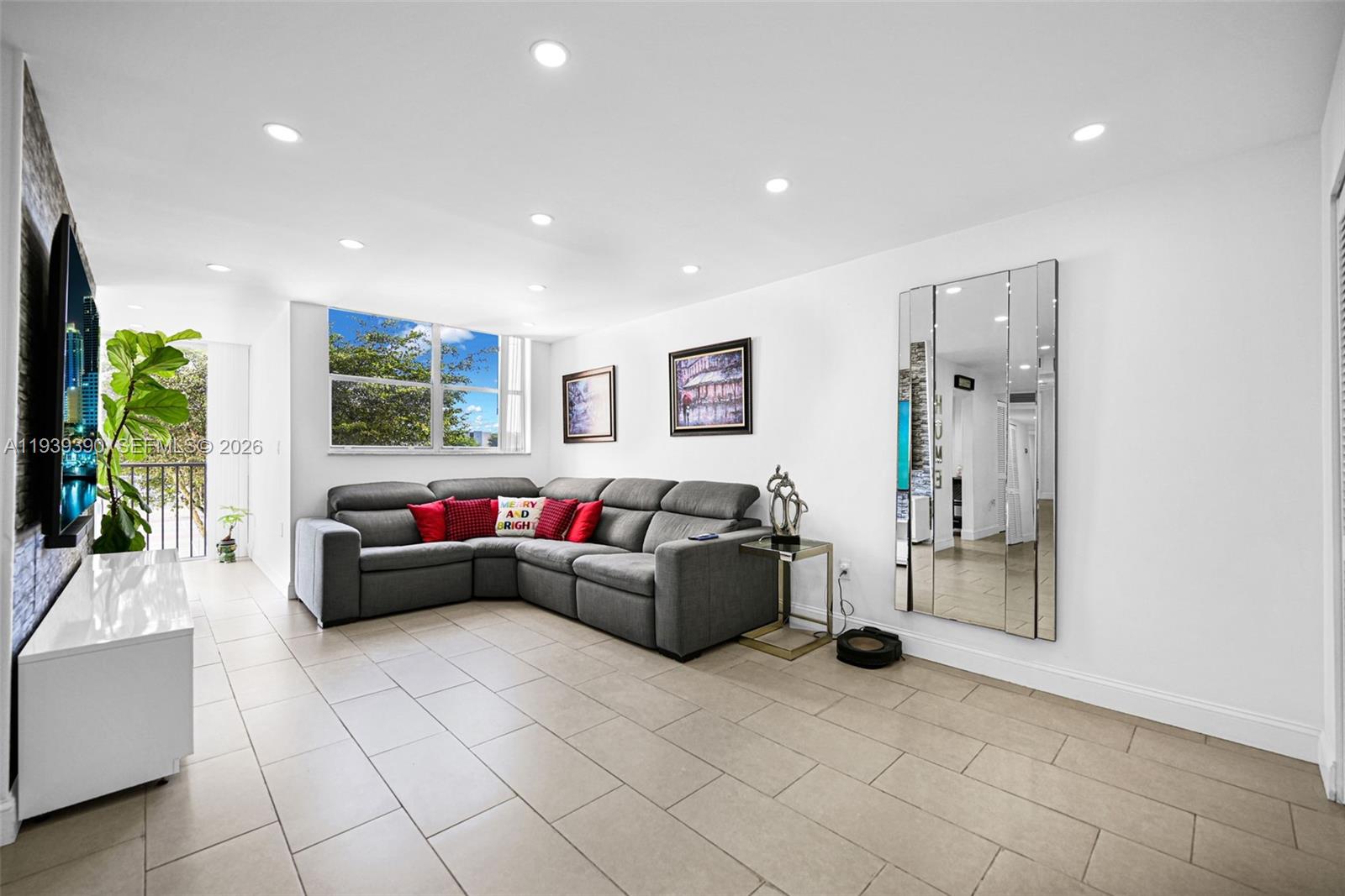 9441 Southwest 4th Street, Unit 309 Miami, FL 33174 - Photo 6 of 44 a living room with furniture and a flat screen tv