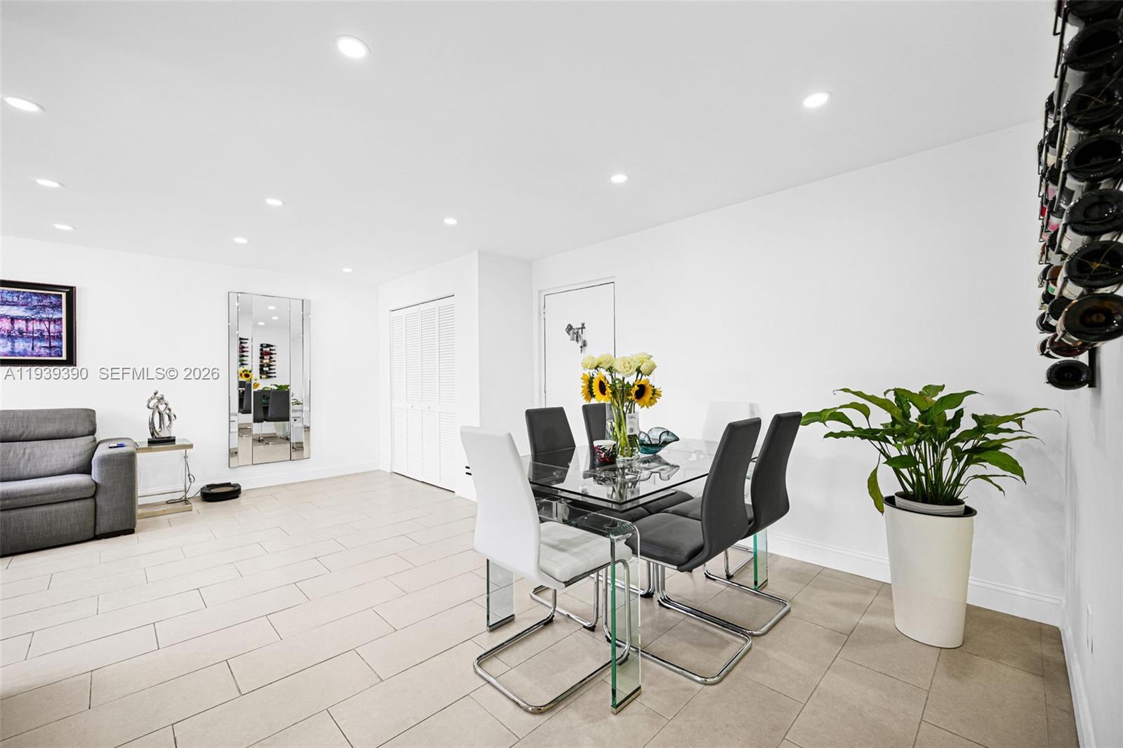 9441 Southwest 4th Street, Unit 309 Miami, FL 33174 - Photo 9 of 44 a dining room filled chandelier and living room view
