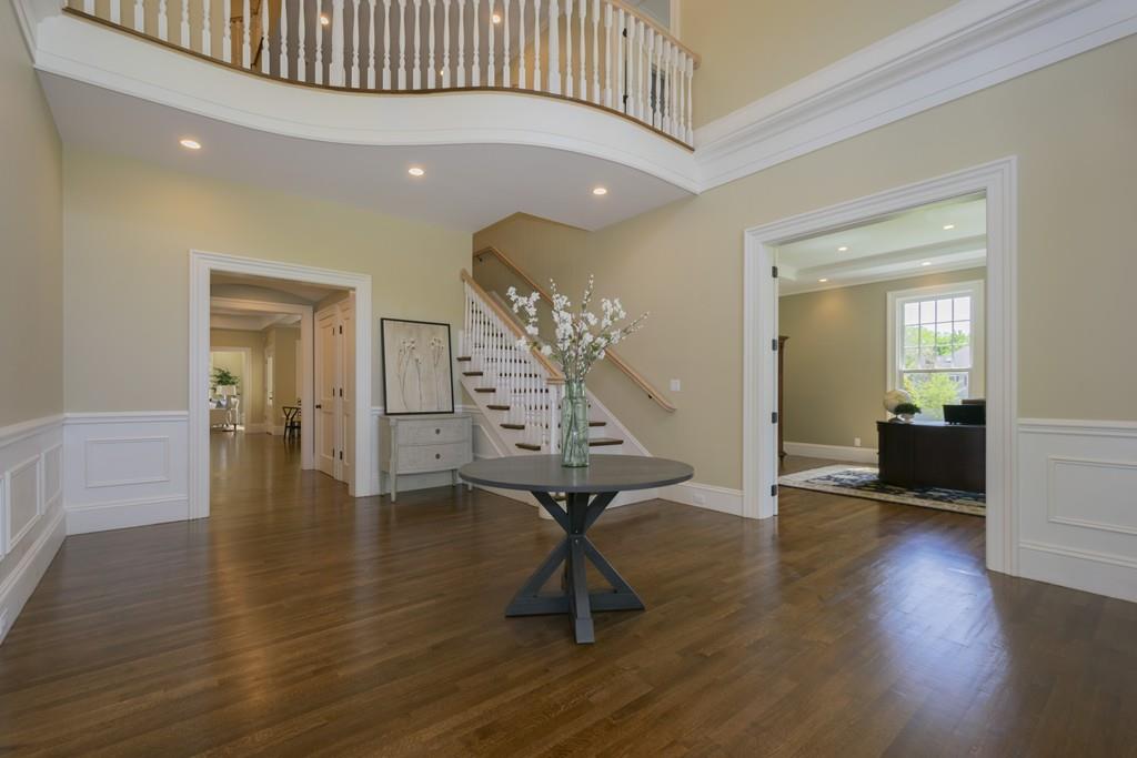 291 Emerson Road Lexington, MA 02420 - Photo 2 of 42 a view of a room with wooden floor staircase and a kitchen