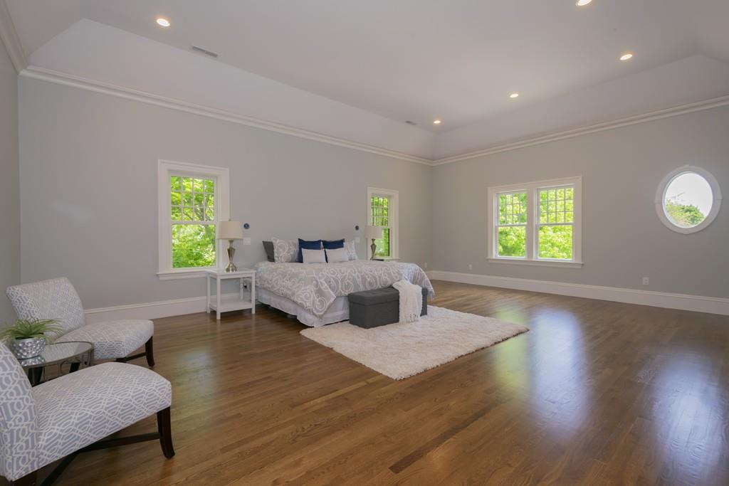 291 Emerson Road Lexington, MA 02420 - Photo 26 of 42 a bedroom with a bed and wooden floor