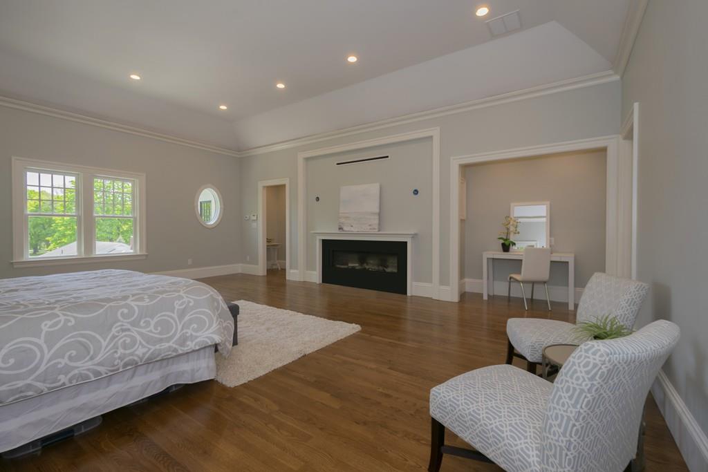 291 Emerson Road Lexington, MA 02420 - Photo 27 of 42 a bedroom with furniture and a fireplace