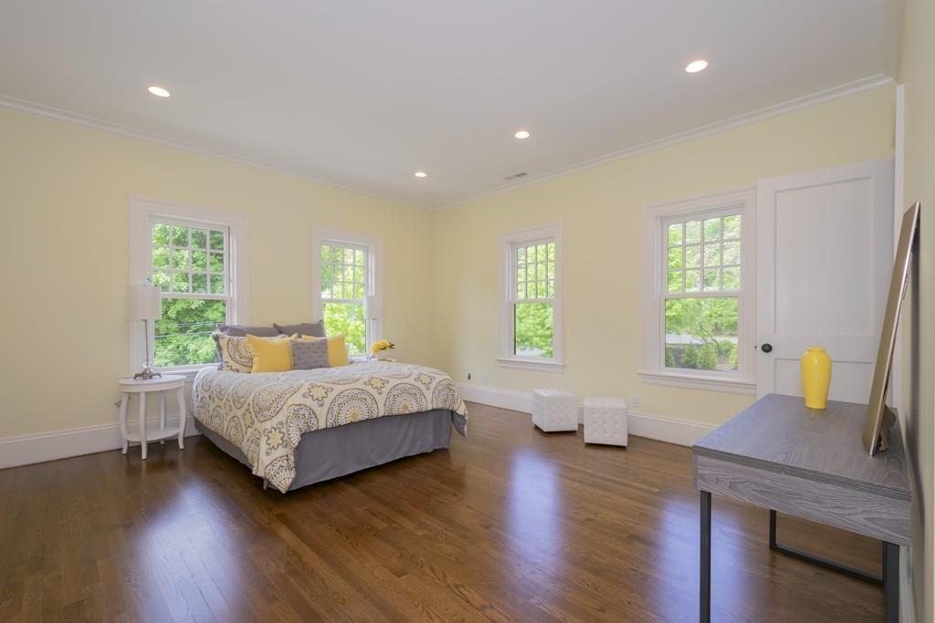 291 Emerson Road Lexington, MA 02420 - Photo 32 of 42 a bedroom with a bed and wooden floor