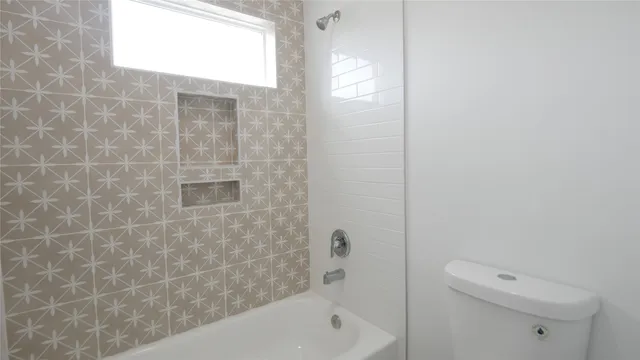 a bathroom with a bathtub and shower
