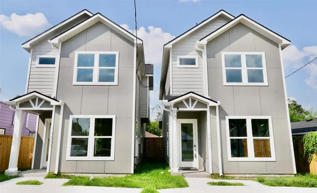 a front view of a house with a yard and porch