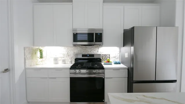 a kitchen with a refrigerator stove and microwave