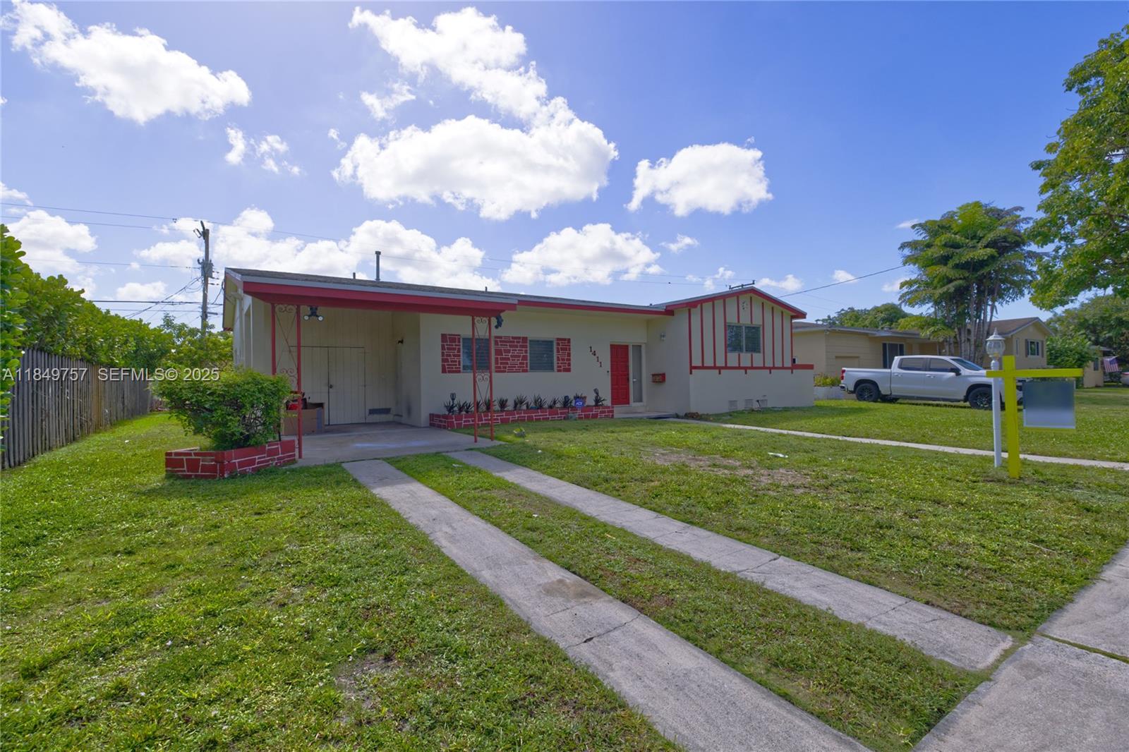 a view of a house with a big yard and a large tree