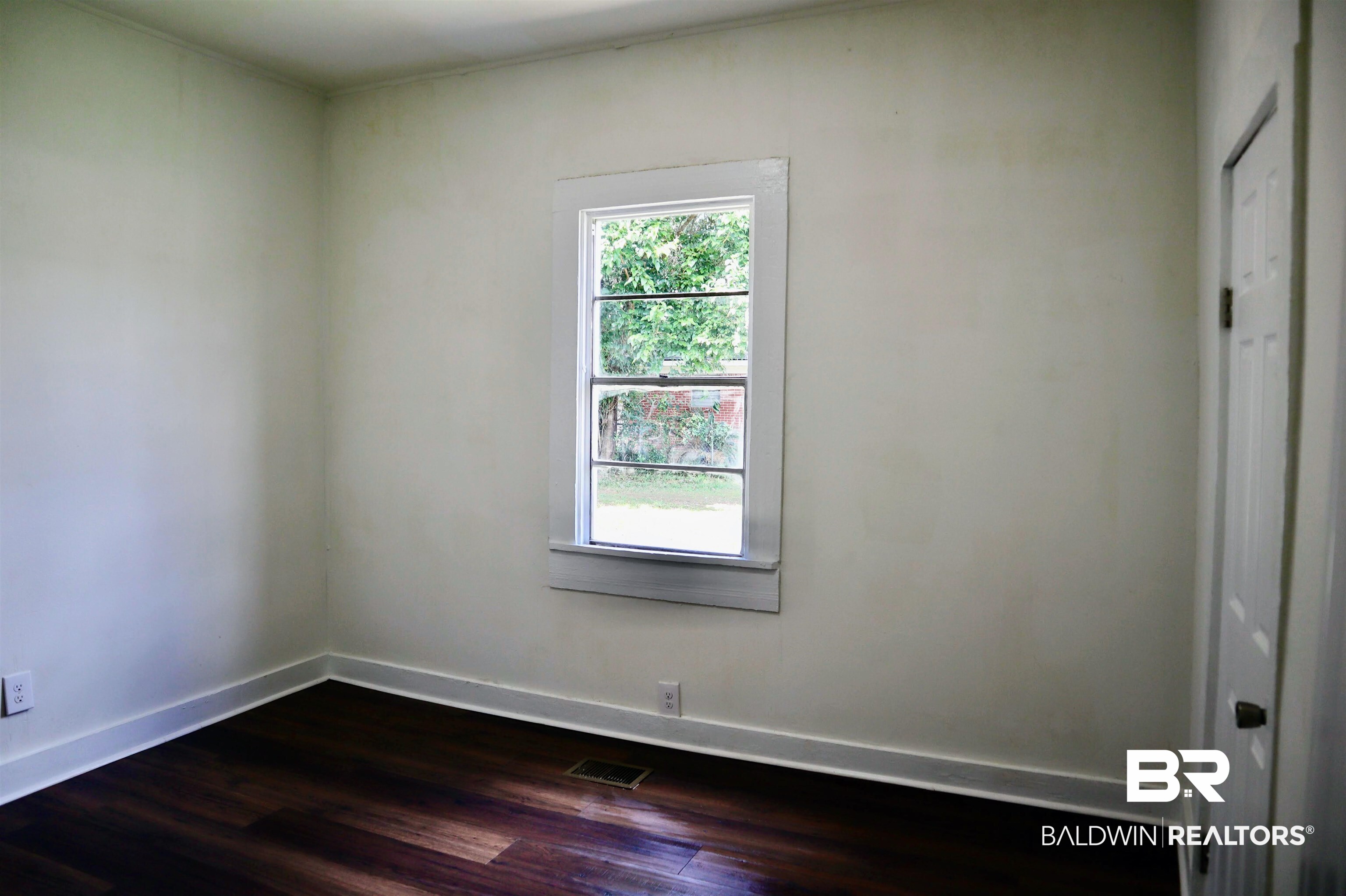 1009 Baltimore Street Mobile, AL 36605 - Photo 10 of 17 Spare room featuring dark wood finished floors and baseboards