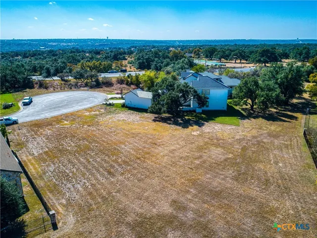 an aerial view of a houses with a yard