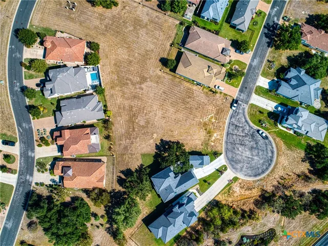 an aerial view of a houses with yard