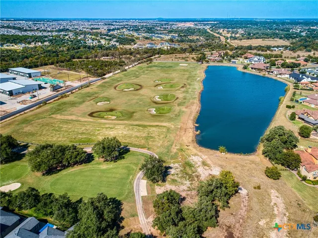 an aerial view of residential houses with outdoor space and swimming pool
