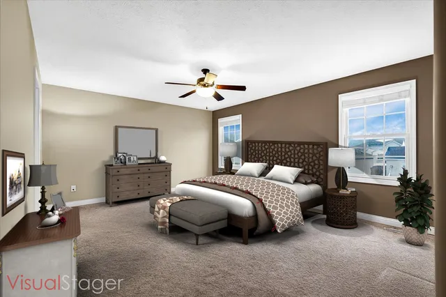 a spacious bedroom with a bed a couch and a potted plant