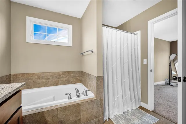 a bathroom with a bathtub and a shower