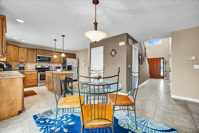 an open kitchen with dining table and chairs