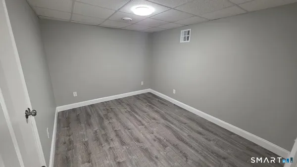 a empty walk in closet with wooden floor