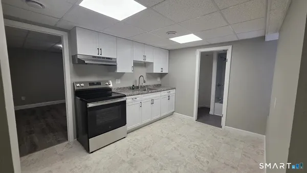 a kitchen with stainless steel appliances granite countertop a stove a refrigerator and a sink