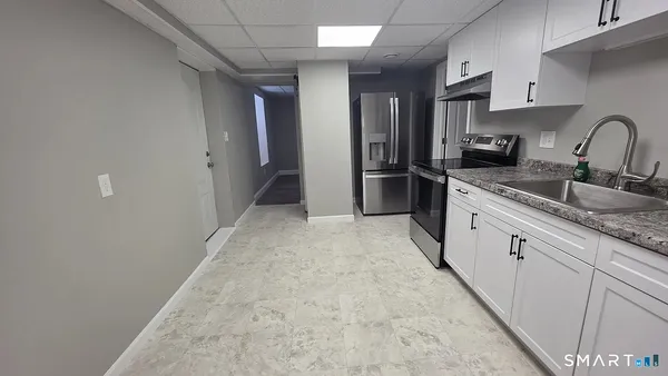a kitchen with stainless steel appliances granite countertop a sink and cabinets