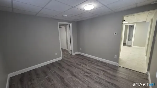 a view of a room with wooden floor and window