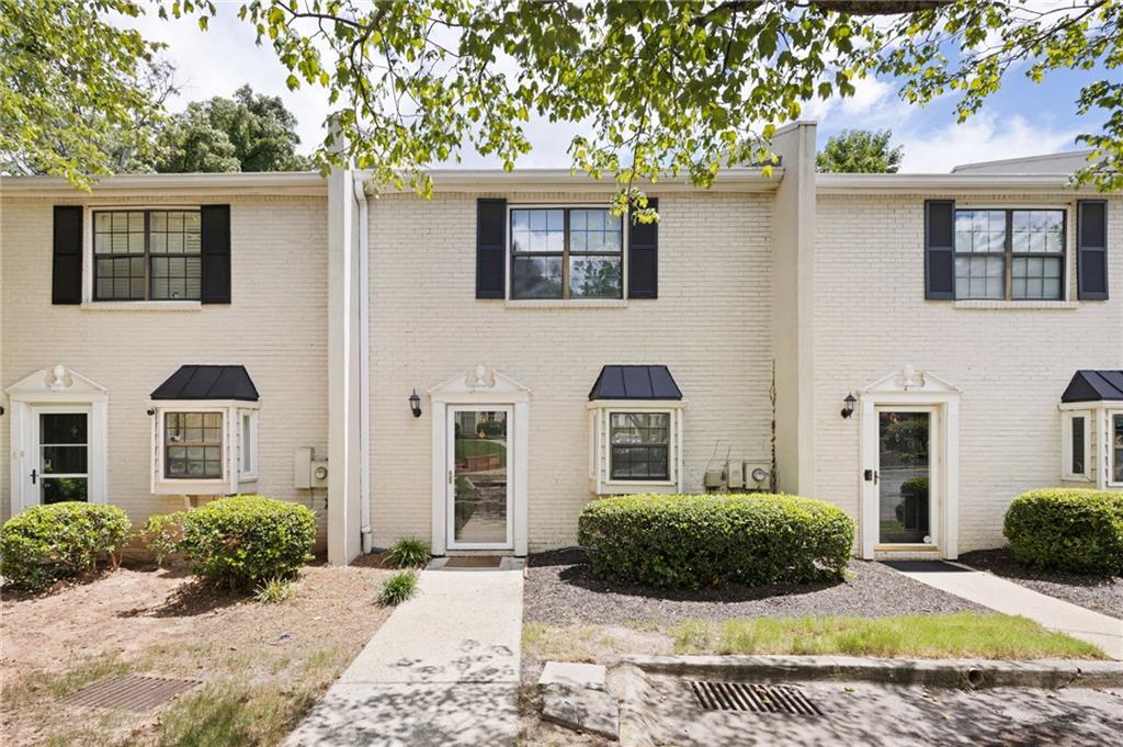 1769 Defoor Avenue Northwest, Unit B Atlanta, GA 30318 - Photo 1 of 1 a view of a house with a yard and potted plants