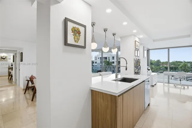 a kitchen with stainless steel appliances granite countertop a sink and a refrigerator