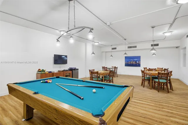 a view of a room with chairs and a chandelier