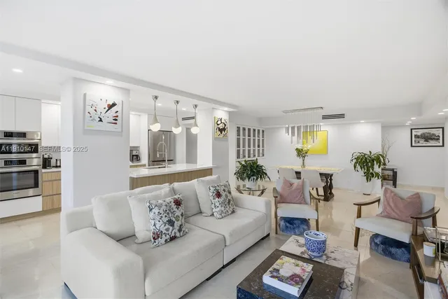 a living room with furniture and painting on the wall next to a window
