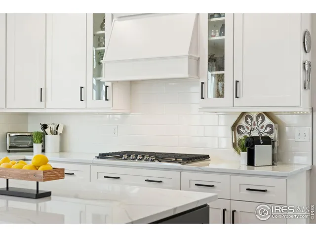 a kitchen with a stove and a white cabinets