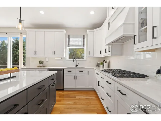 a kitchen with stainless steel appliances kitchen island granite countertop a sink stove and cabinets
