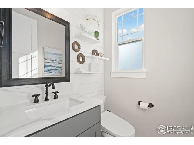 a bathroom with a sink mirror and shower