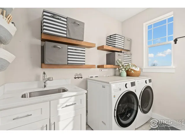 a utility room with sink dryer and washer