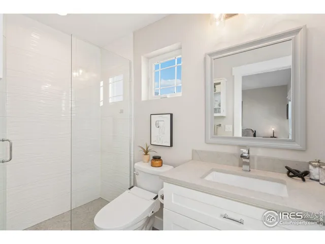 a bathroom with a sink vanity granite and a mirror