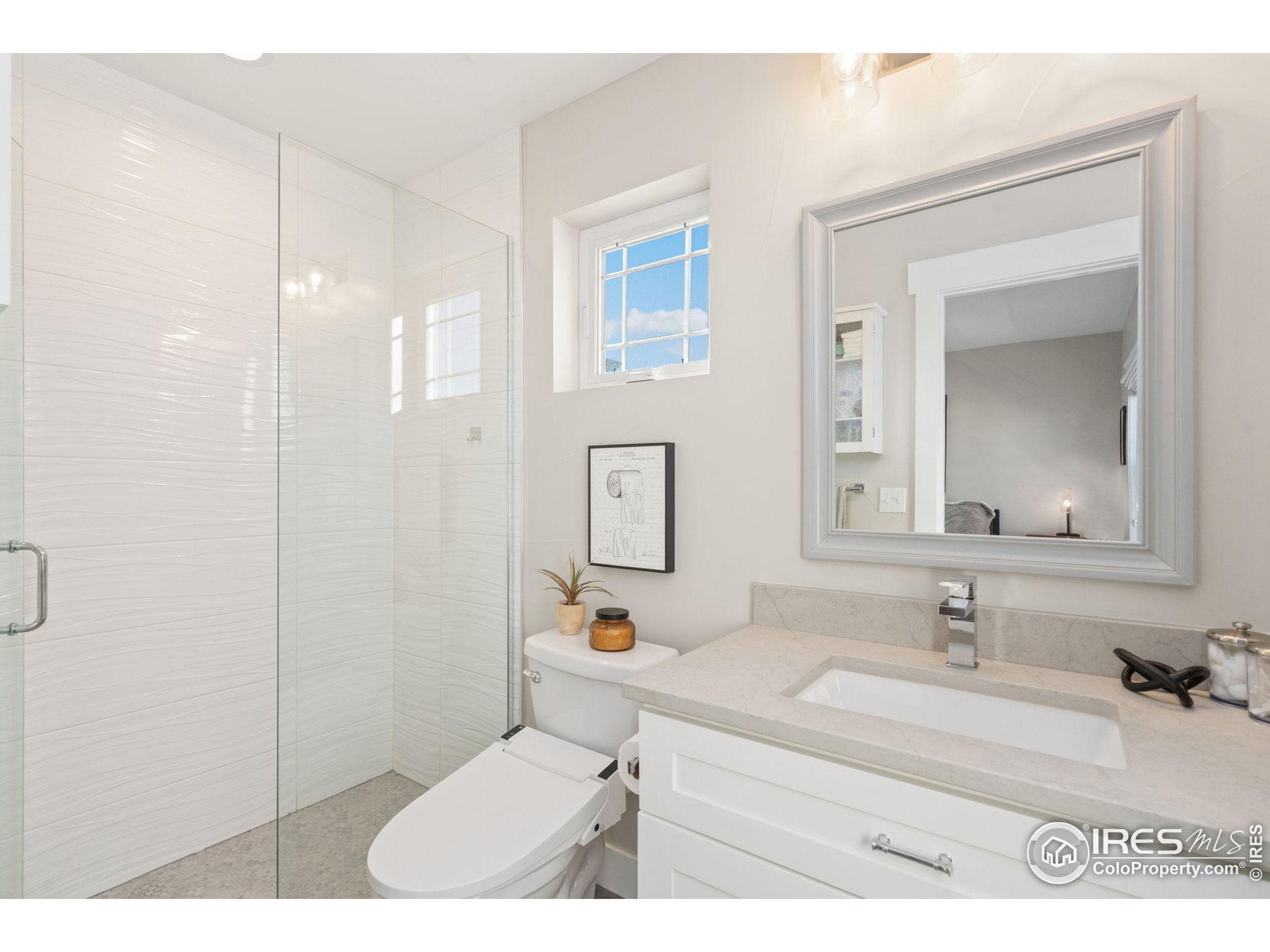 2032 Cuda Court Berthoud, CO 80513 - Photo 28 of 38 a bathroom with a sink vanity granite and a mirror